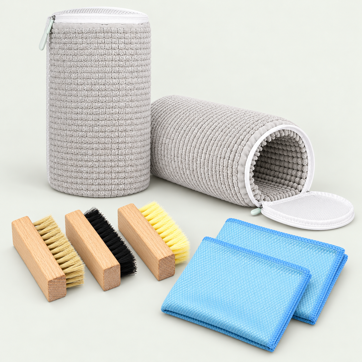 Weekly Reset Kit containing two grey wash bags, three wooden brushes and two blue microfibre cloths
